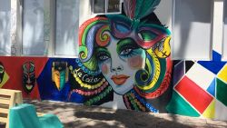 Photo of street art in La Ceiba showing a graphitti are of a woman on a wall