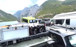 Cars and a bus on a ferry with a nice view on the back